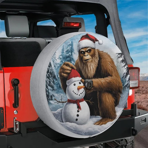 Sasquatch Holiday Tire Cover, Bigfoot Building Snowman Spare Tire Cover, Humorous Winter Scene Wheel Cover, Christmas Present